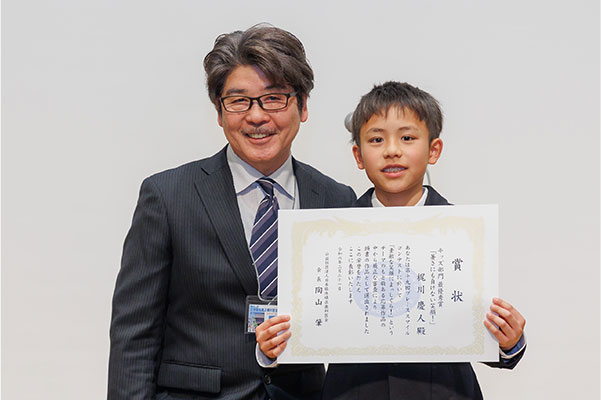 副会長の佐藤先生から賞状を受け取る梶川慶人さん